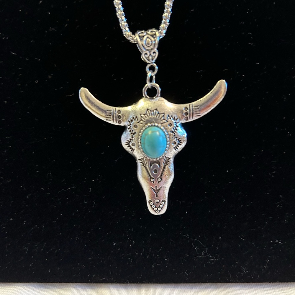 Western Steer Head Necklace in Silver with a turquoise stone on its forehead.New